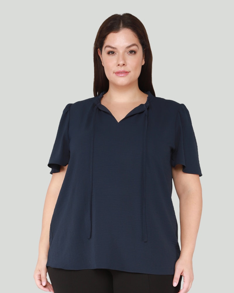 Front of a model wearing a size 0X Angie Flutter Sleeve Top in Dark Blue by DEX PLUS. | dia_product_style_image_id:268389
